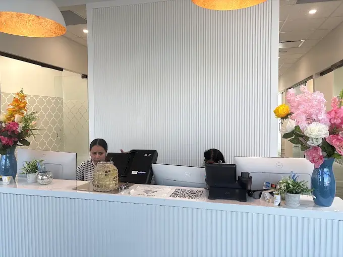 The bright front desk at Cornerbrook Smiles Dental, staffed and decorated with fresh flowers